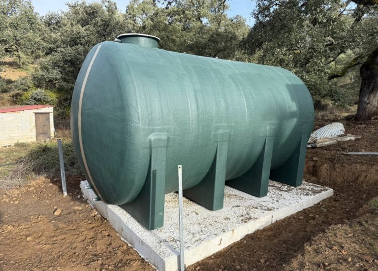 Depósito horizontal verde con apoyos sobre una base de hormigón